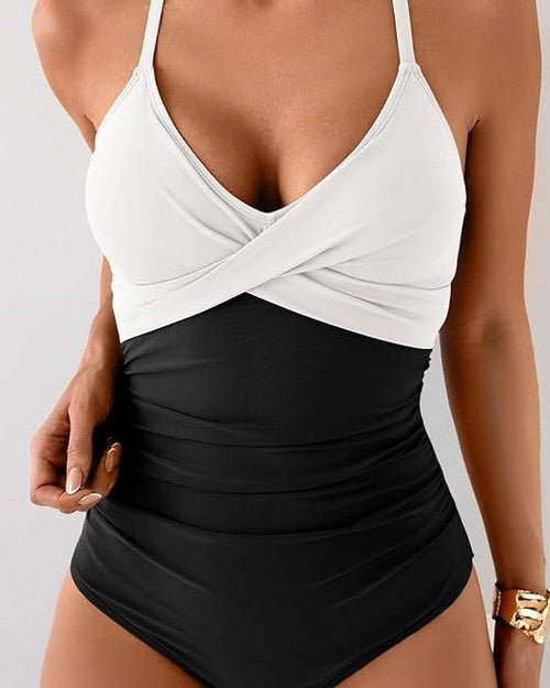 Two-tone swimsuit with white top and black bottom on a neutral background