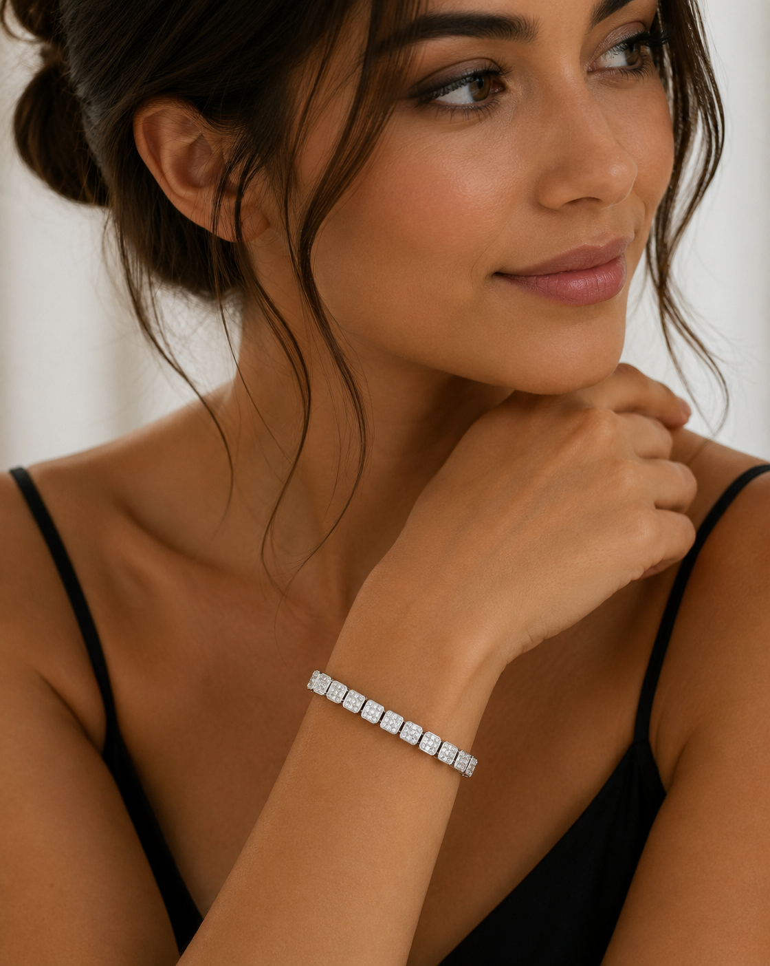 Woman wearing a silver bracelet on her wrist with a blurred background