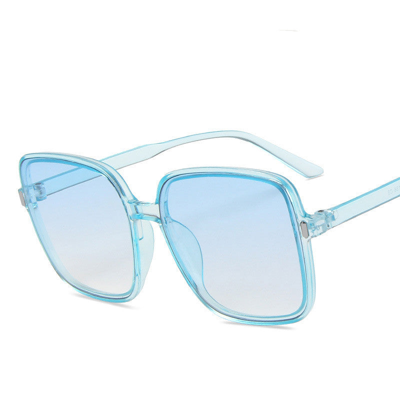 Blue sunglasses with a clear frame on a white background