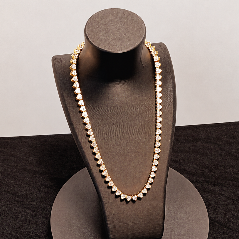 Pearl necklace on a brown jewelry stand against a black background