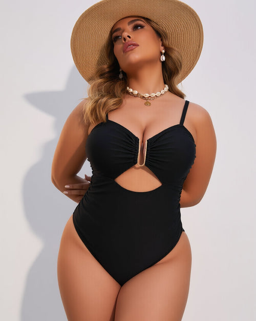 Woman wearing a black one-piece swimsuit and straw hat on a white background