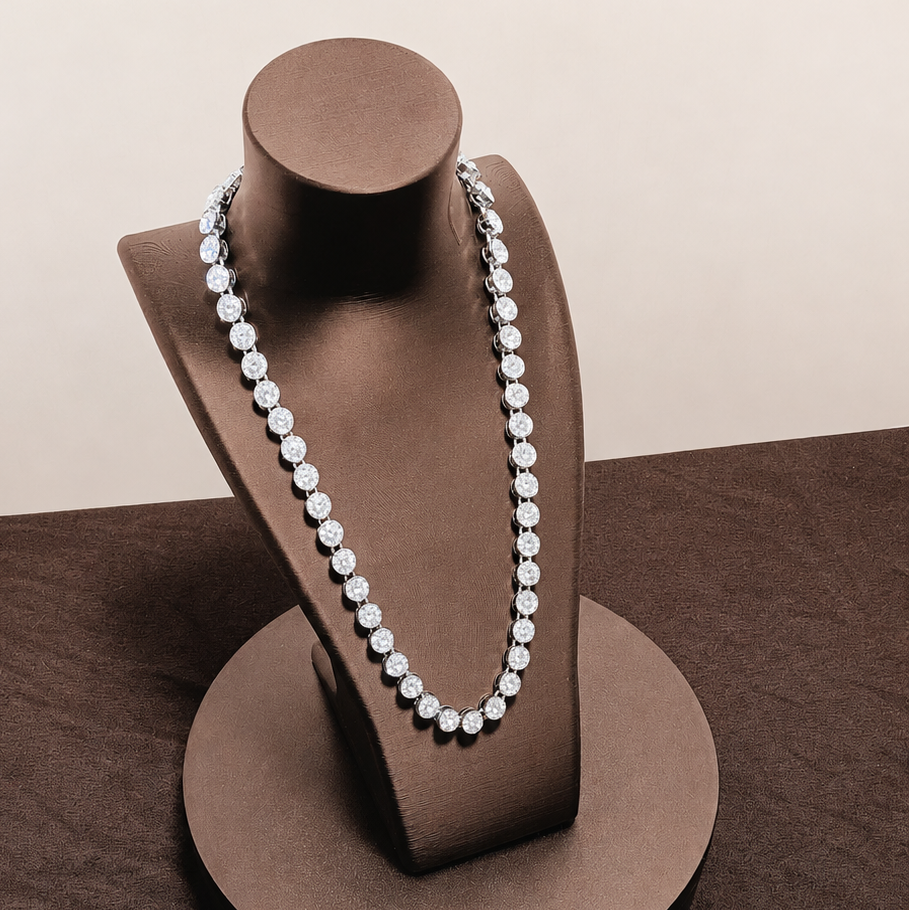 Pearl necklace on a brown jewelry stand against a beige background