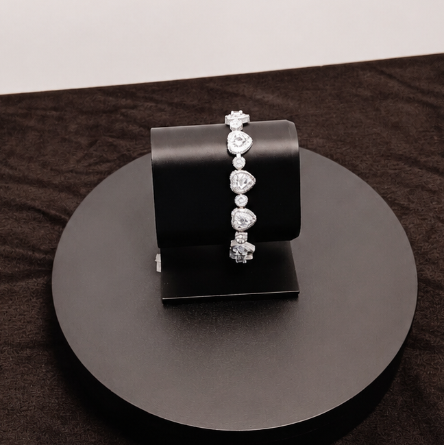 Jewelry display with earrings on a black stand against a white background
