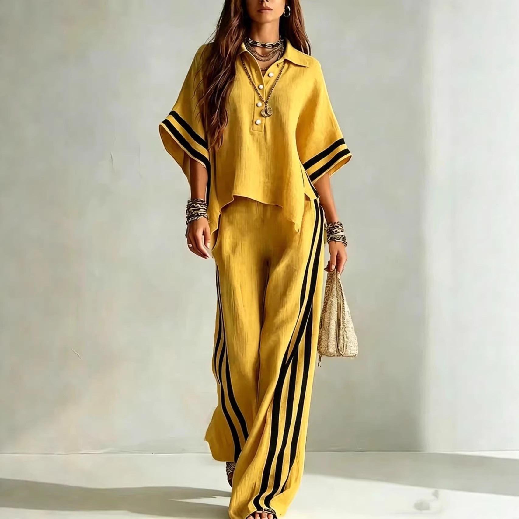Woman wearing a yellow outfit with black stripes on a plain background