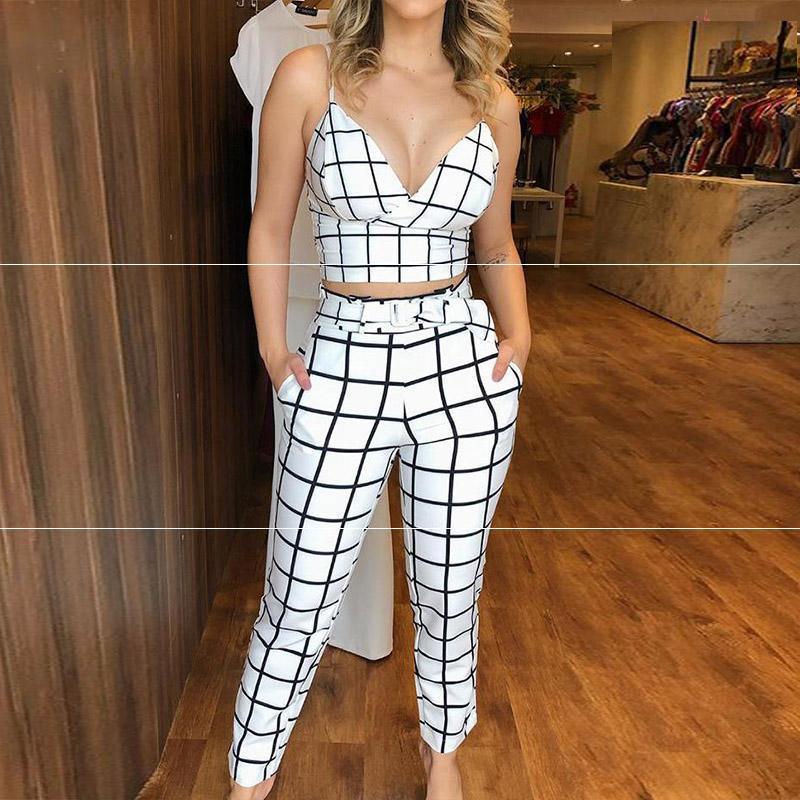 Woman wearing a black and white grid-patterned outfit in a store setting.