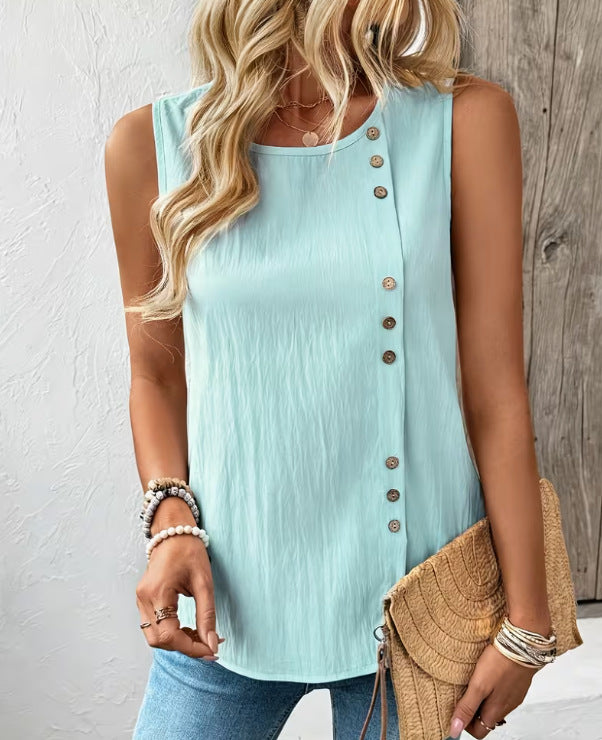 Woman wearing a light blue sleeveless button-up top with a wooden background