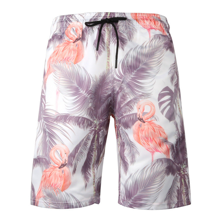 Floral and flamingo patterned shorts on a white background