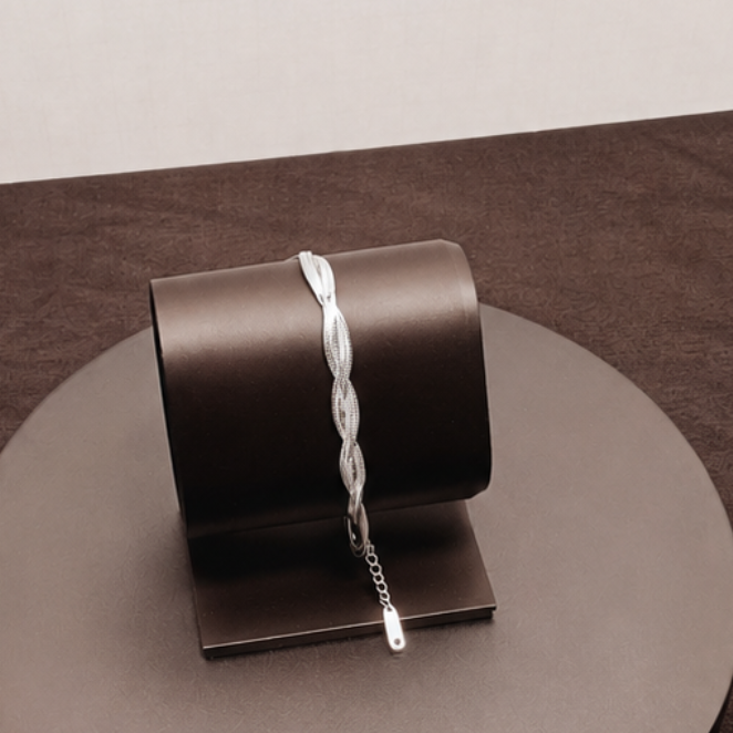 Metallic cylindrical object on a reflective surface with a neutral background