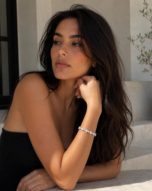 Woman with long dark hair wearing diamond bracelet 