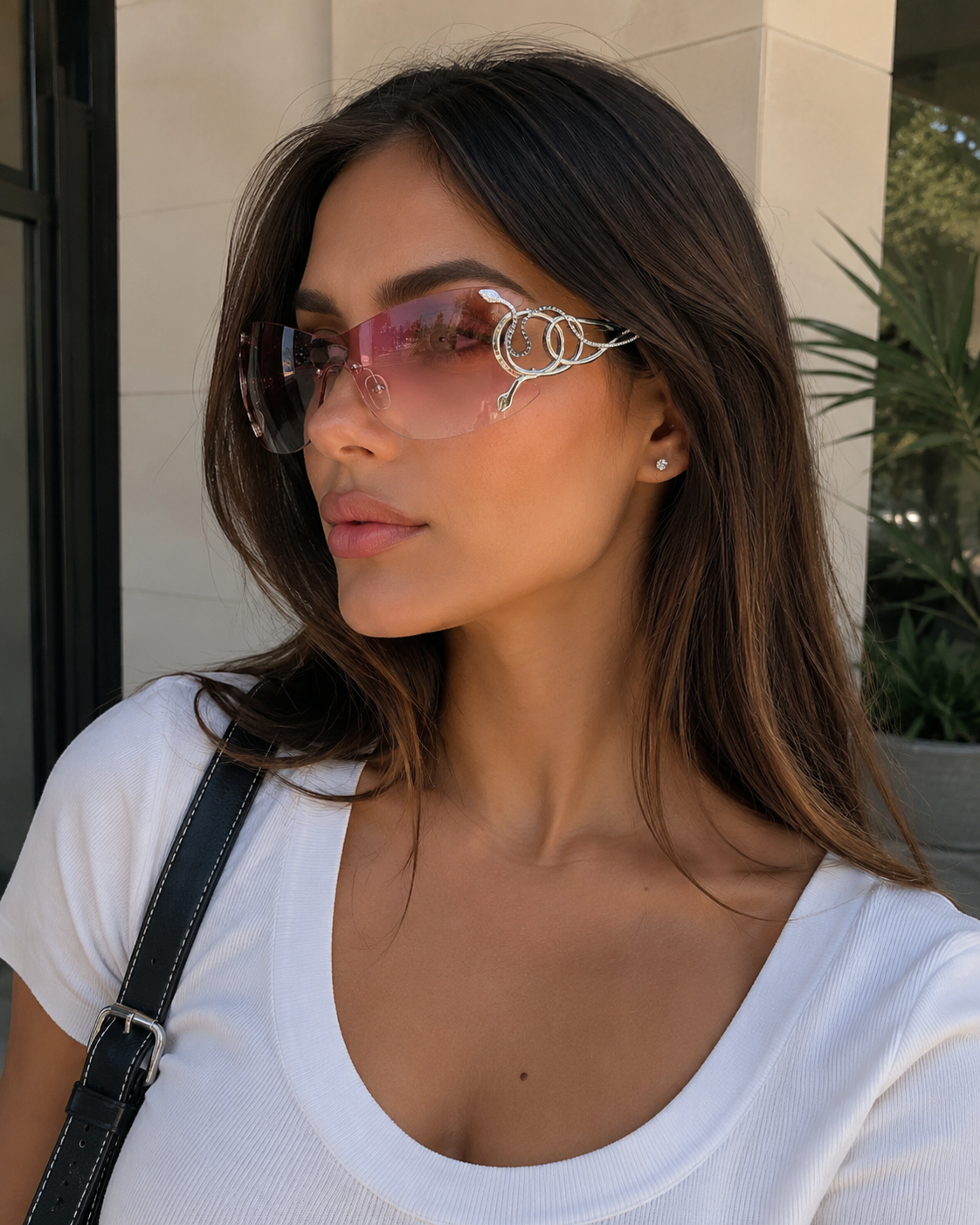 Woman wearing pink sunglasses with a neutral background