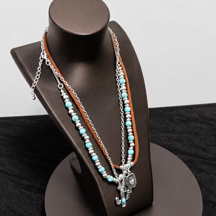 Necklace on a black jewelry stand against a black background