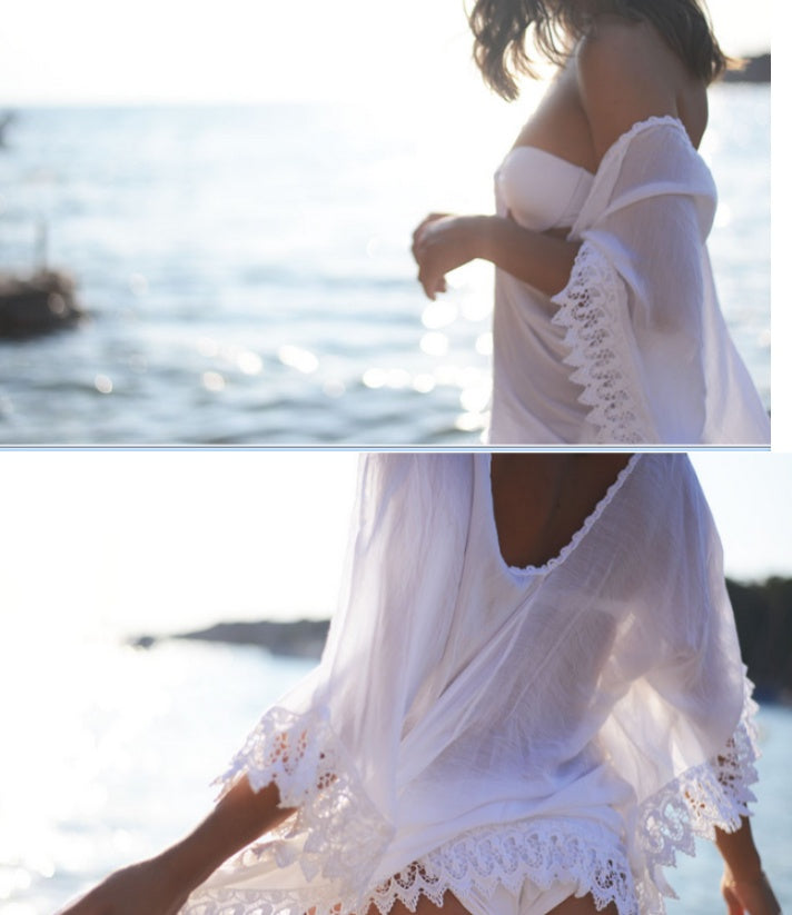 Woman wearing a white lace cover-up by the water