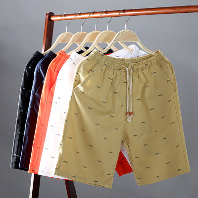 Beige shorts with a pattern on a rack against a gray background