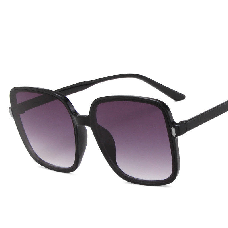 Black sunglasses with gradient lenses on a white background