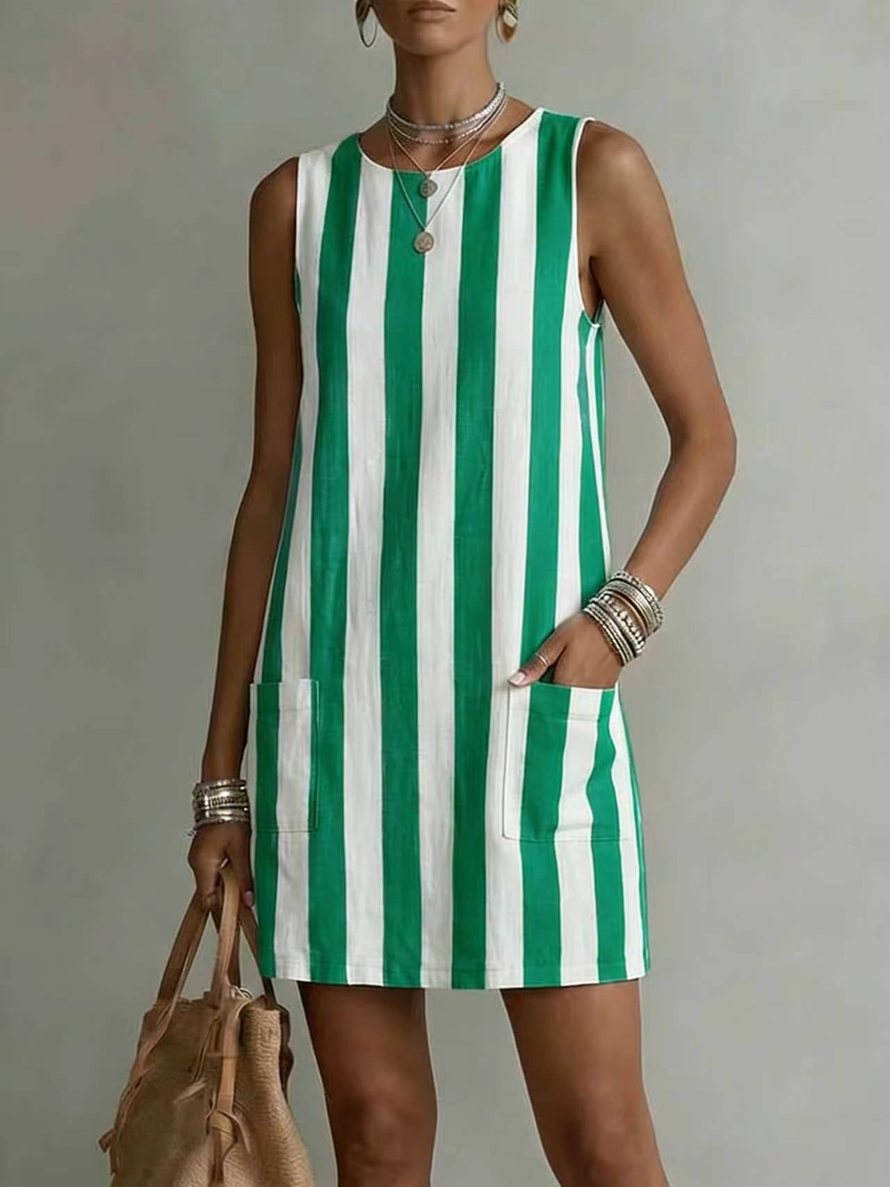 Woman wearing a green and white striped dress against a neutral background
