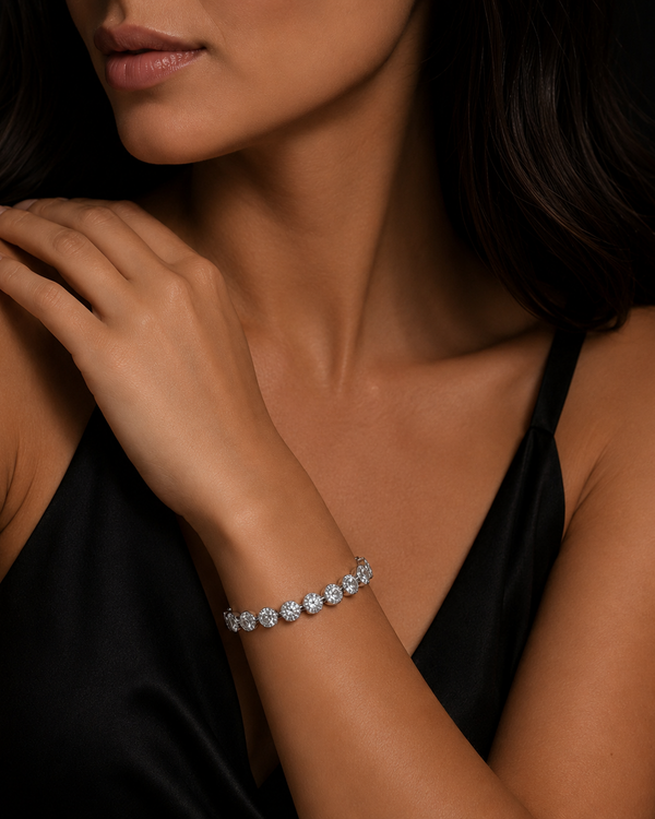 Woman wearing a cz bracelet on a dark background