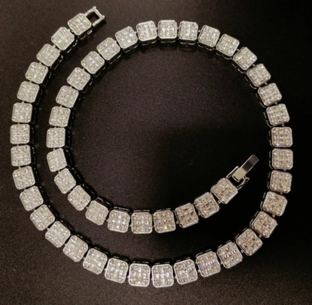 Two diamond-encrusted necklaces on a black background