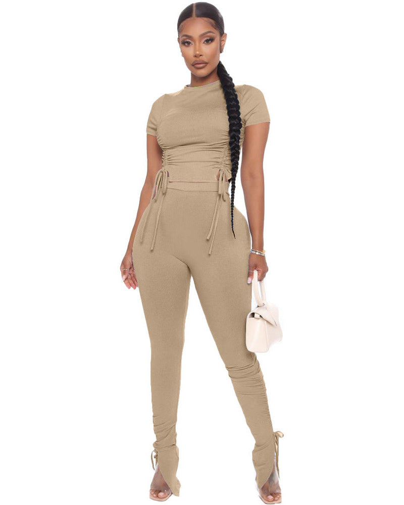 Woman wearing a beige jumpsuit on a white background