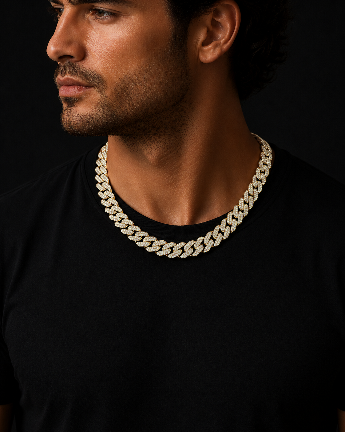 Man wearing a gold chain necklace against a black background