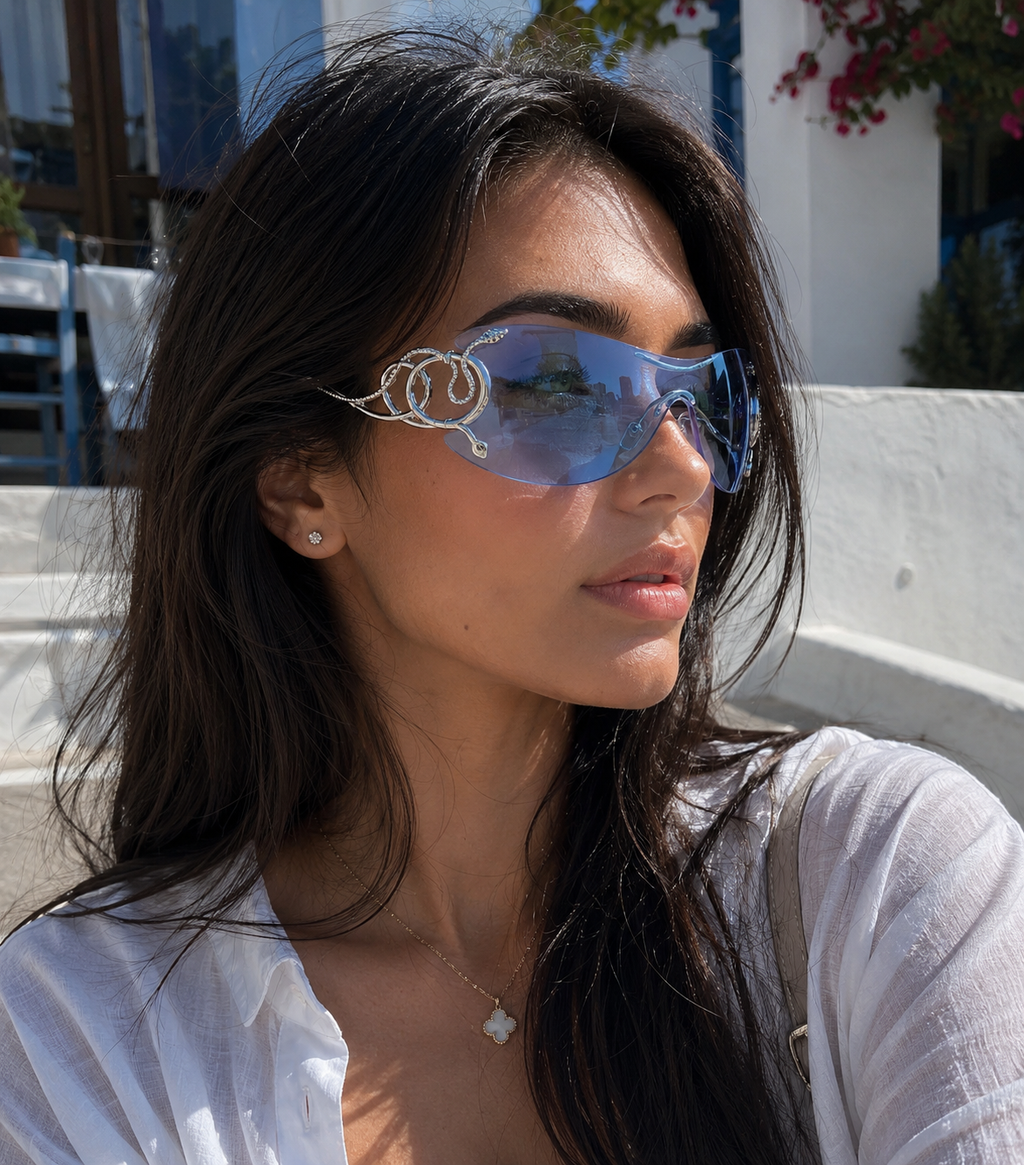 Woman wearing large reflective sunglasses outdoors