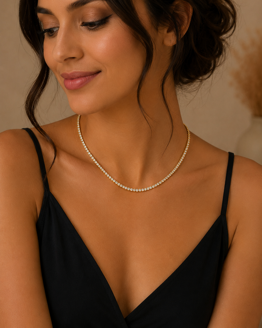 Woman wearing a delicate necklace with a neutral background