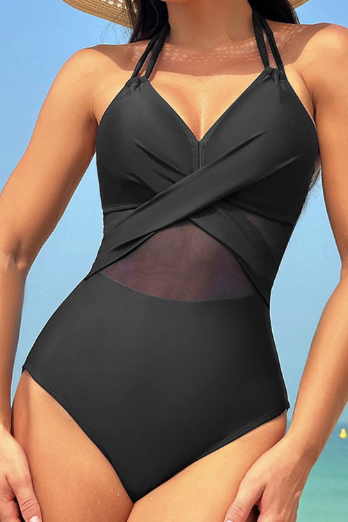 Black swimsuit worn by a person with a clear blue sky background