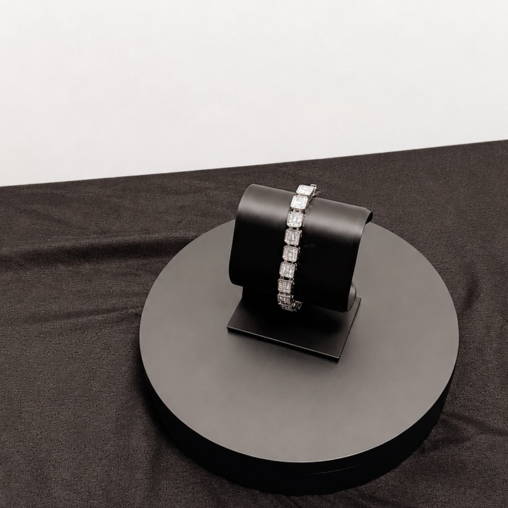 Black bracelet on a round black stand with a white background