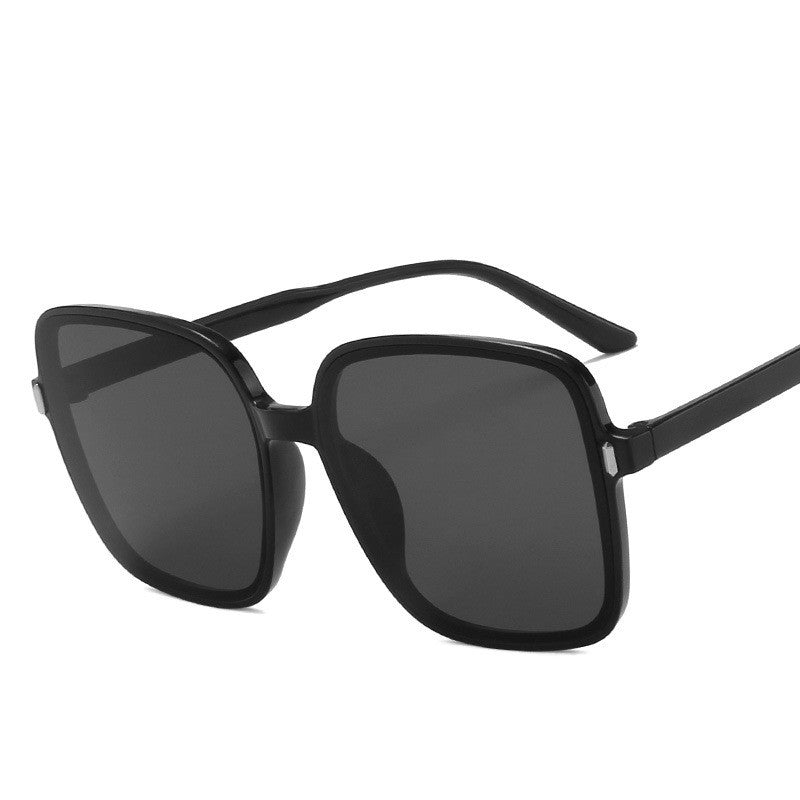 Black sunglasses with dark lenses on a white background