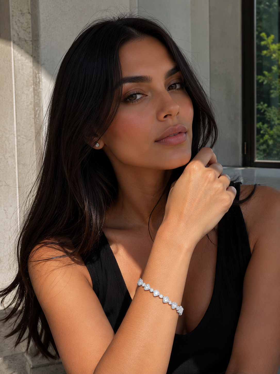 Woman wearing a bracelet with a neutral background