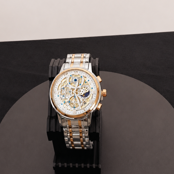 Luxury watch with a detailed face on a black platform against a white background