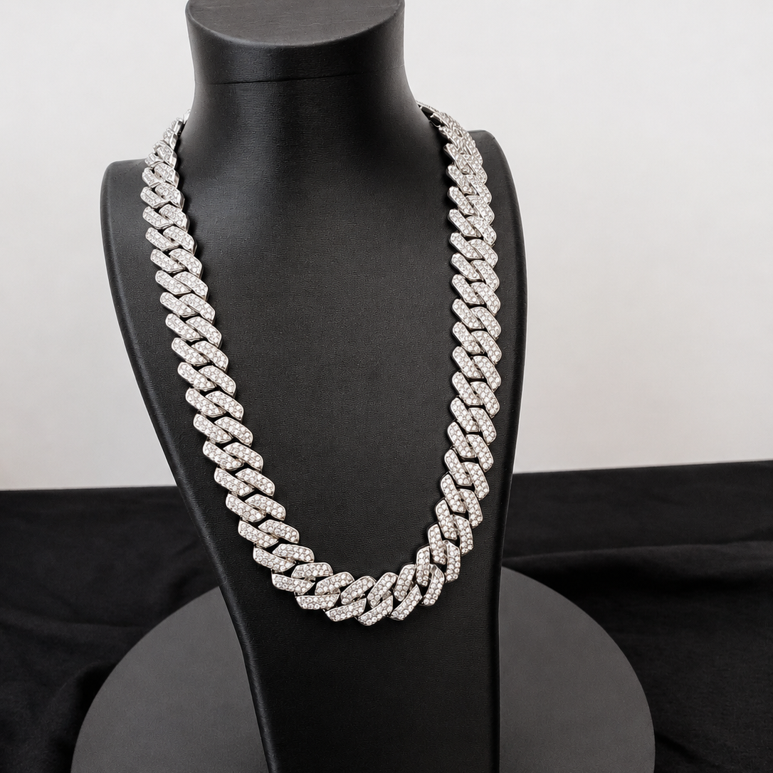 Silver chain necklace on a black mannequin bust against a white background