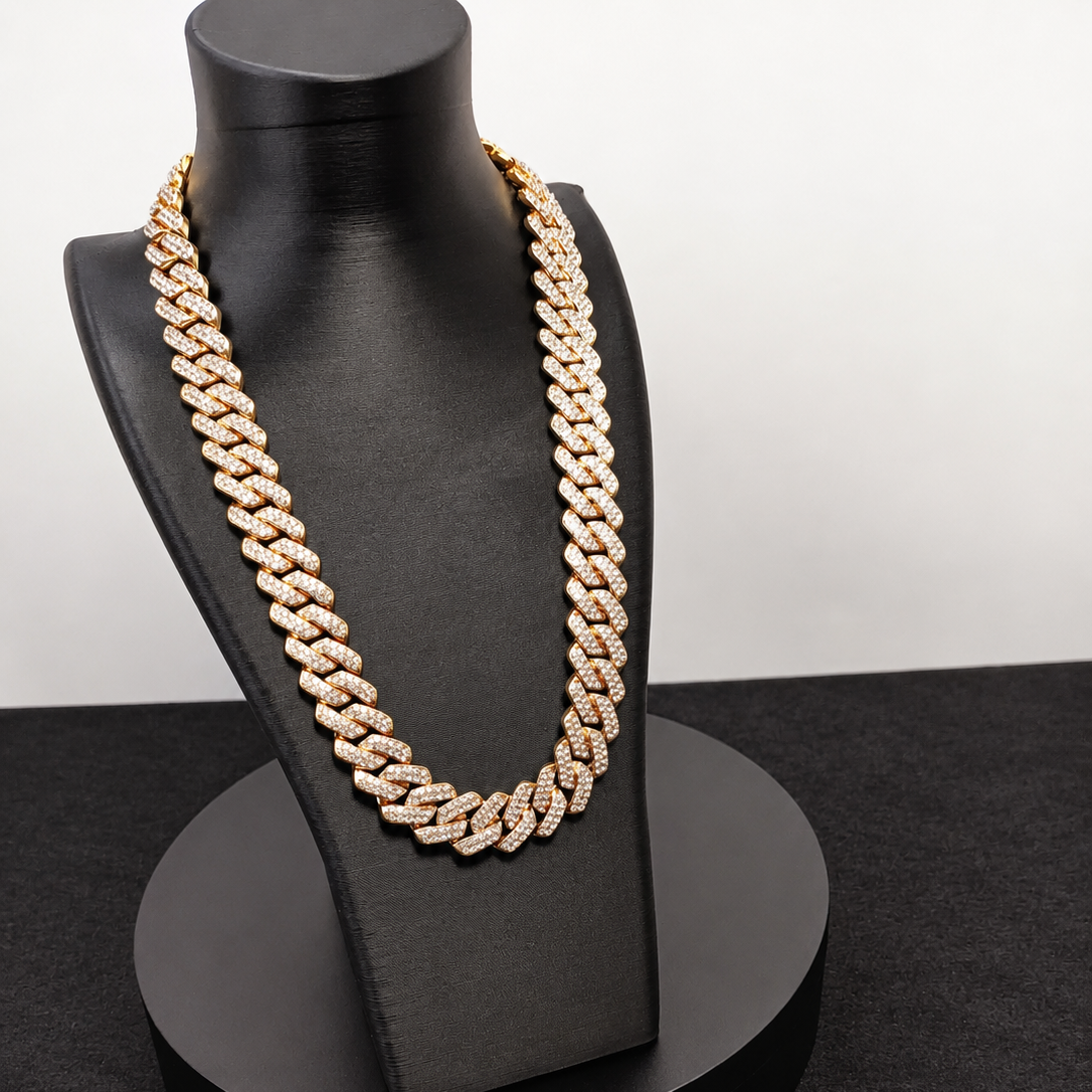 Gold chain necklace on a black mannequin bust against a white background