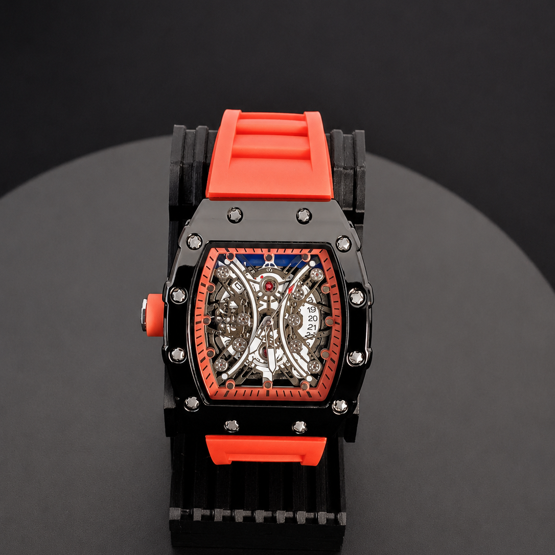 Watch with a red and black strap on a dark surface