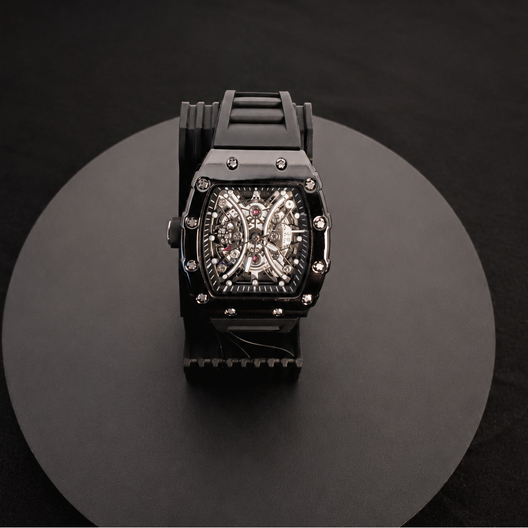 Black wristwatch with detailed face on a black and white background