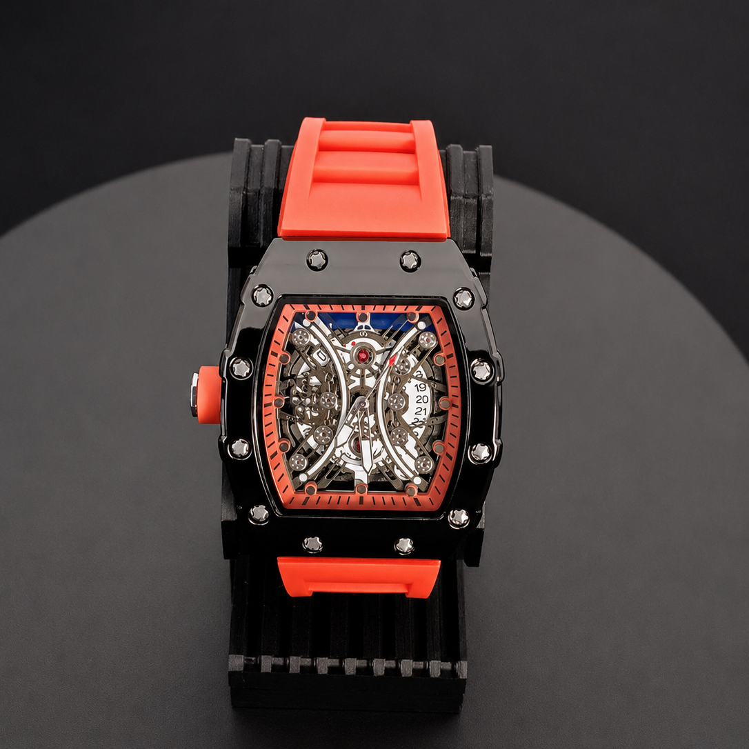Watch with a orange and black strap on a dark surface