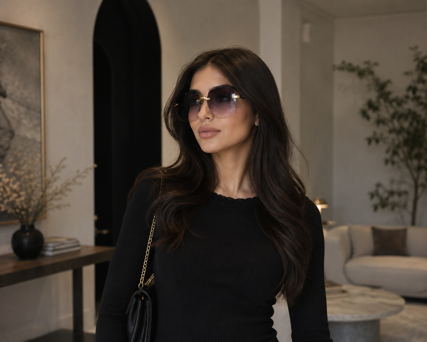 Woman wearing sunglasses and a black outfit in an indoor setting