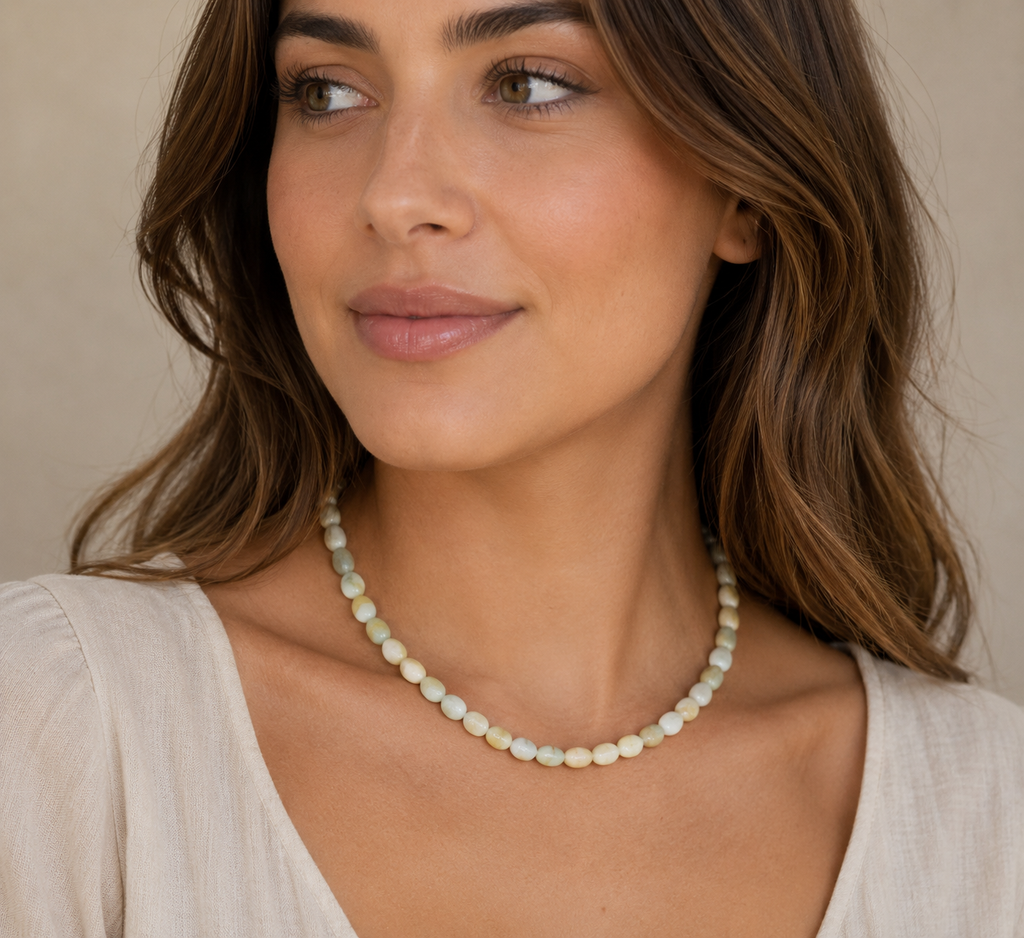 Woman wearing a necklace against a neutral background