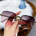 Sunglasses with gradient lenses held by a hand, with text indicating color gradient.