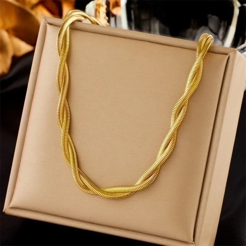 Gold necklace on a beige box with blurred background