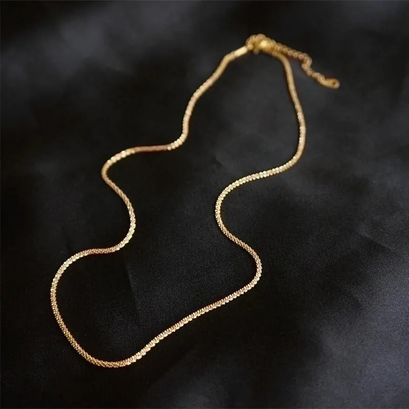 Gold necklace on a black background