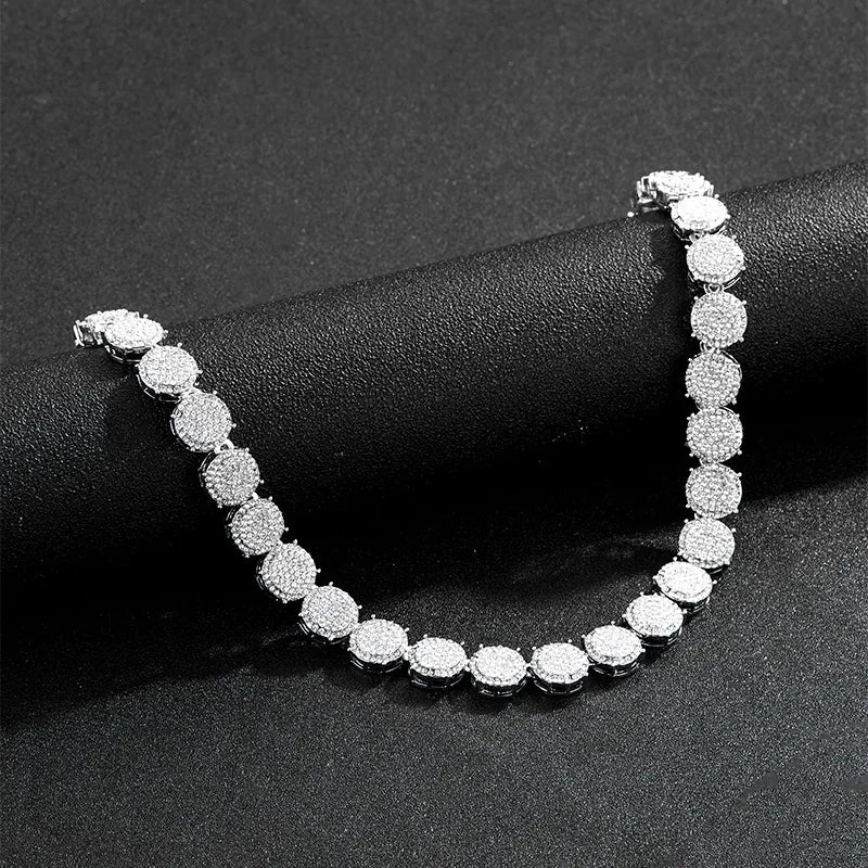 Silver bracelet with clear stones on a black surface