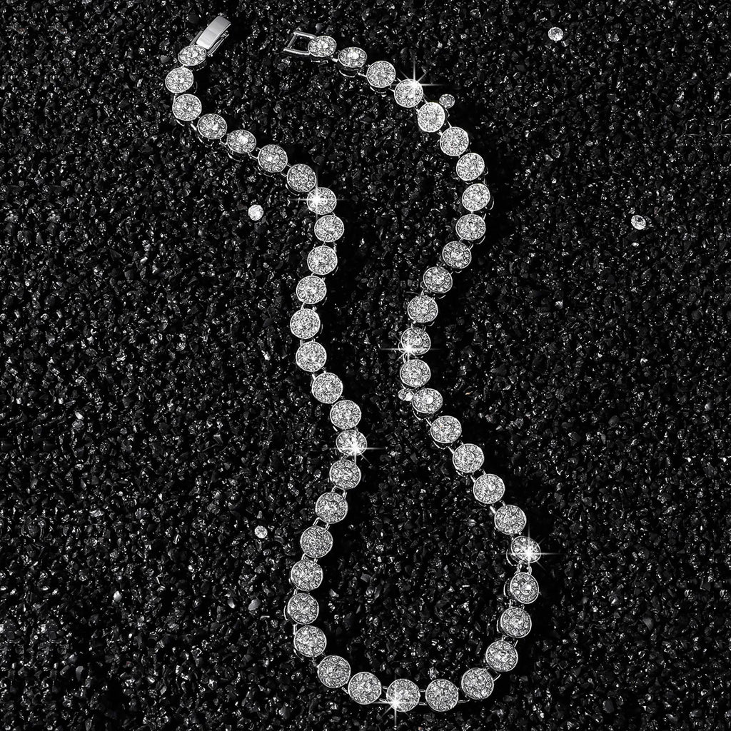 Silver beaded necklace on a black textured background