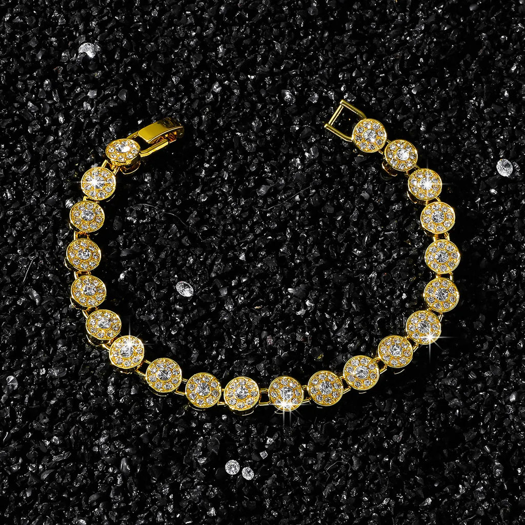 Gold bracelet with clear stones on a black textured background