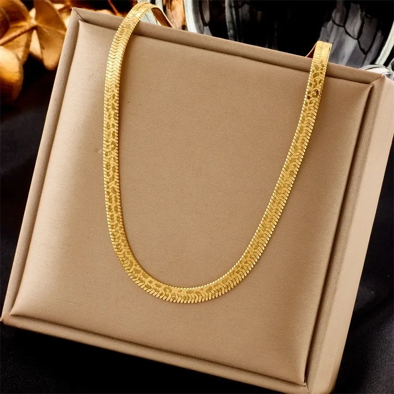 Gold necklace on a beige box with a blurred background
