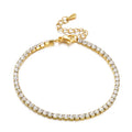 Gold bracelet with clear stones on a white background