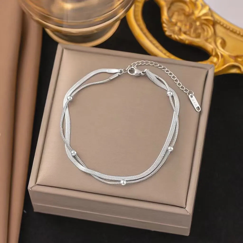 Silver necklace on a jewelry box with a decorative background