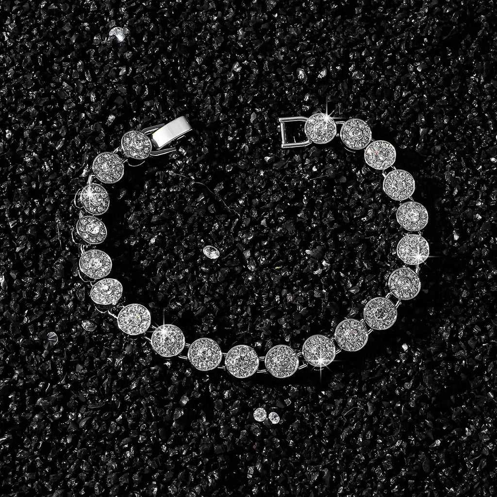Silver bracelet with clear stones on a black textured surface