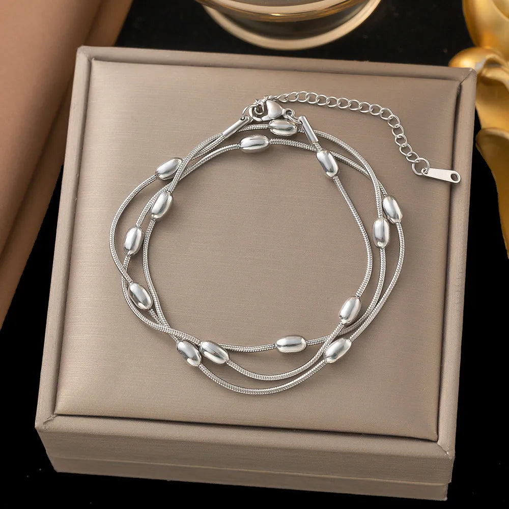 Silver bracelet on a beige jewelry box with a blurred background