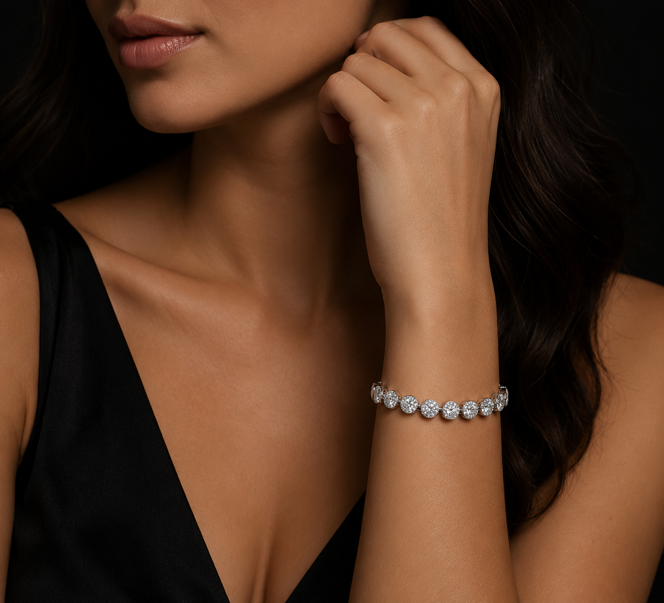 Close-up of a woman wearing a cz bracelet on a dark background