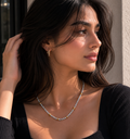 Woman wearing a necklace with a neutral background